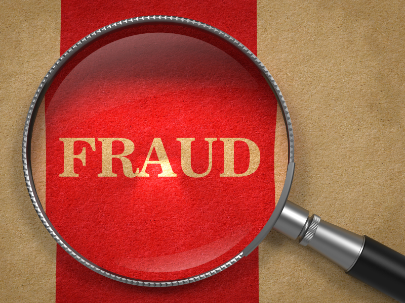 Fraud Concept – Magnifying Glass.