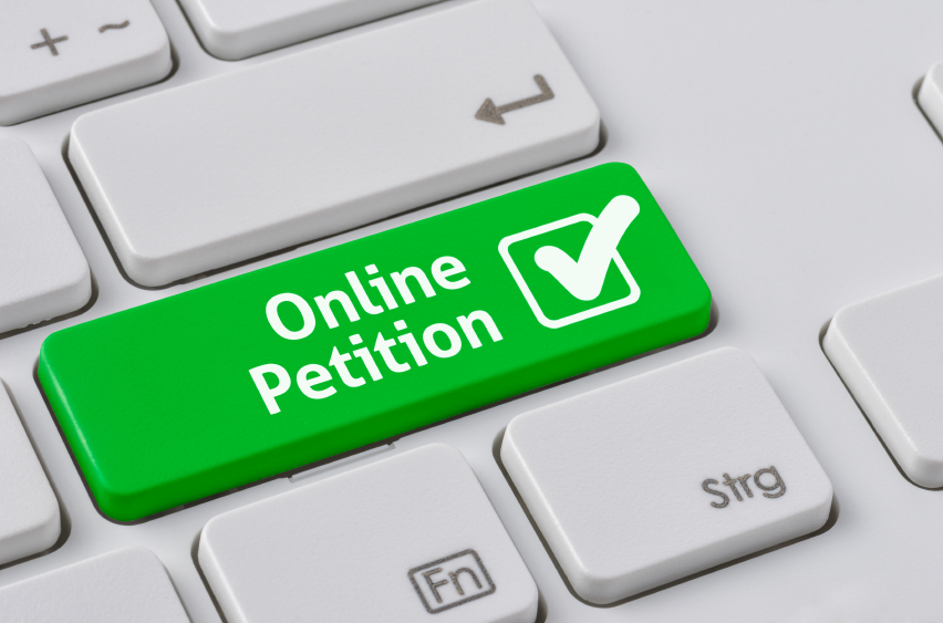 A keyboard with a green button – Online Petition